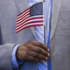 A man holds a U.S. flag prior to taking the citizenship oath to become a U.S. citizen during a naturalization ceremony at the U.S. Patent and Trademark Office in Alexandria, Va., May 28, 2015.
SAUL LOEB/AFP/Getty Images
